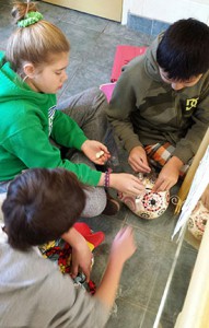 Children in pajamas counting coins