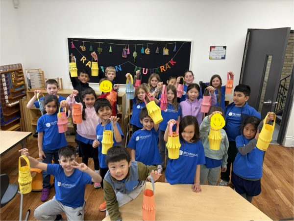 Group of Lower Elementary students holding handmade paper fanous - lanterns to celebrate Ramadan.